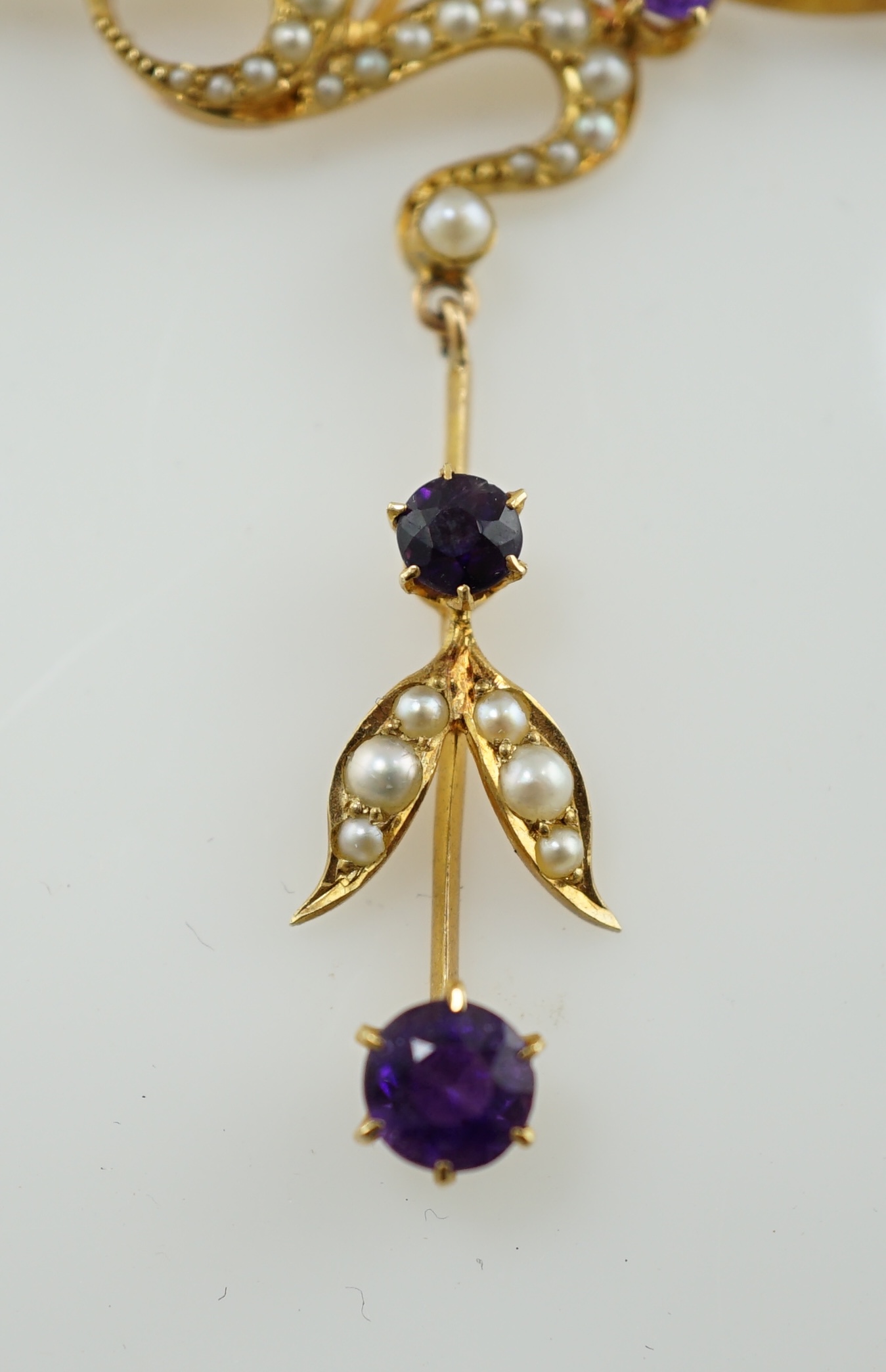 An Edwardian 15ct gold, seed pearl and amethyst set drop necklace and a pair of matching unmarked earrings